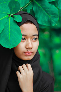 Close-up portrait of young woman with eyes closed