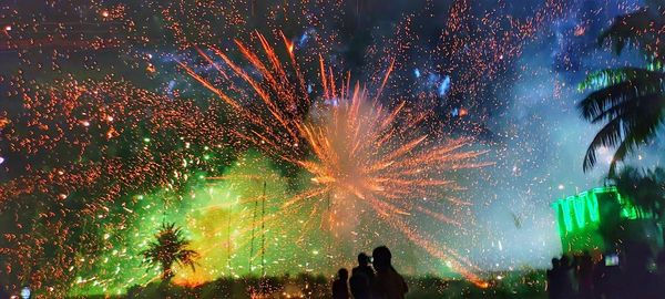 Low angle view of firework display at night