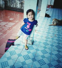 Portrait of cute girl playing with dog