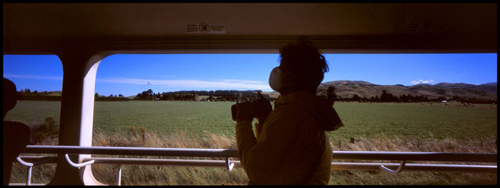 Rear view of man looking at field