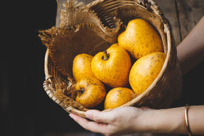 Close-up of man holding pumpkin in basket