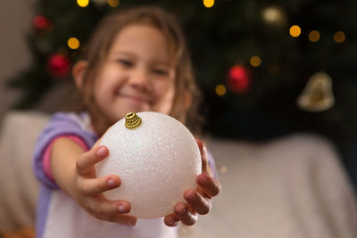 Close-up of girl holding christmas tree