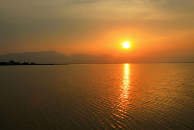 Scenic view of sea against romantic sky at sunset