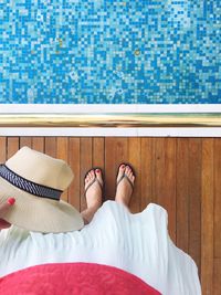Low section of woman standing at poolside
