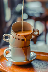 Close-up of coffee cups on table