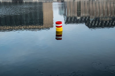 Reflection of lighthouse on puddle at lake