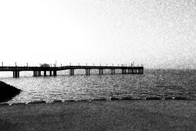 Pier on sea against clear sky