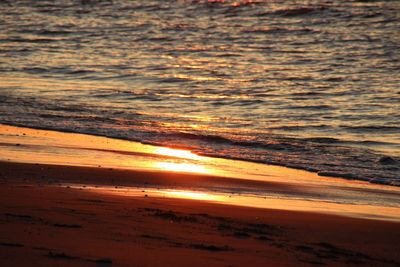 Scenic view of beach against sky during sunset