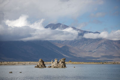 Scenic view of sea and mountains against sky