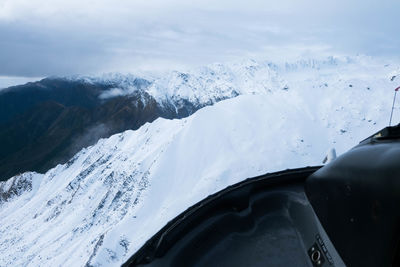 Close-up of snow covered mountains against sky