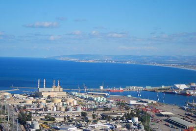 High angle view of city by sea against sky