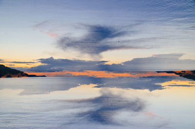 Scenic reflection of clouds in calm sea