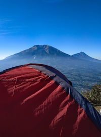 Scenic view of mountain range against blue sky