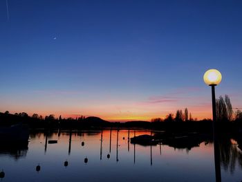 Scenic view of lake against sky at sunset