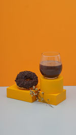 Still life photography of donut cake with chocolate topping and coffe beans