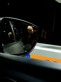 Reflection of man in car