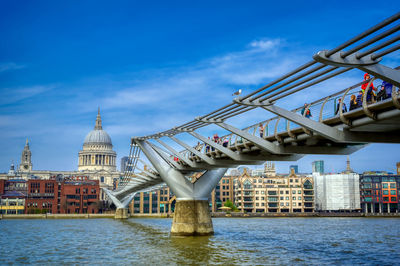 Bridge over river with city in background