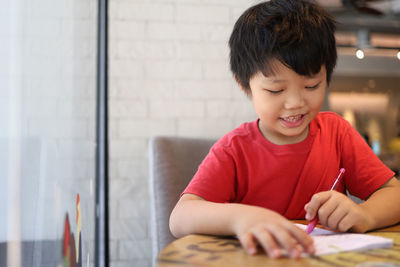 Portrait of boy looking at table