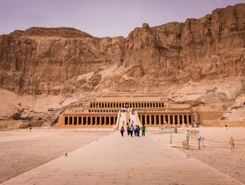 People walking in front of historical building