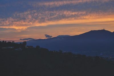 Scenic view of silhouette mountains against sky during sunset