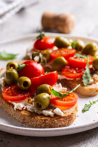 Plate with bruschettas and glass of wine