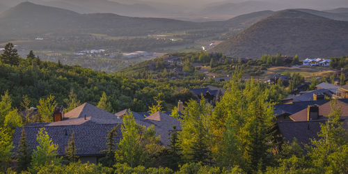 High angle view of houses and trees against mountains