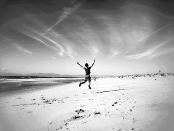 Full length of a man jumping on beach