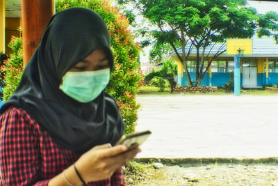 Man using mobile phone in park