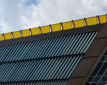 Low angle view of building against cloudy sky