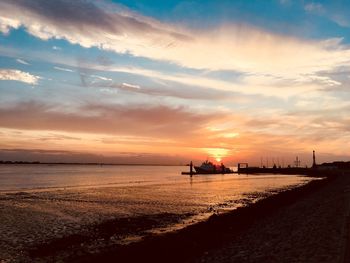 Scenic view of beach against sky during sunset