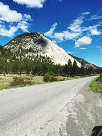 Empty road by mountain against sky