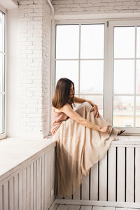 Woman looking at window