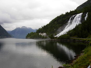 Scenic view of lake and mountains against sky