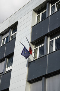 Low angle view of college structure with french and european flag.