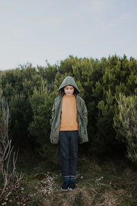 Full length of boy standing on field