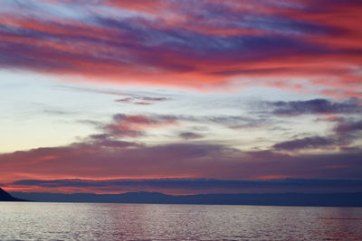 Scenic view of sea against romantic sky at sunset