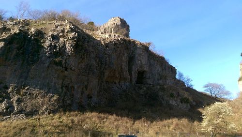 Low angle view of rock formations against blue sky
