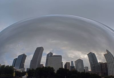 Digital composite image of modern buildings against sky