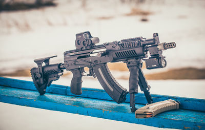 Close-up of toy on pier against sea