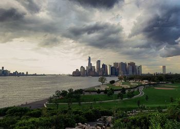 View of modern buildings against cloudy sky