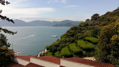 High angle view of sea and buildings against sky