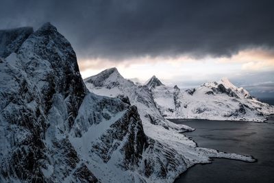 Scenic view of snowcapped mountains against sky during sunset