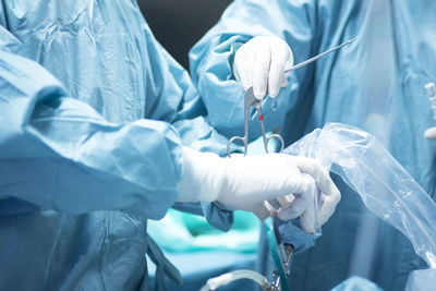 Midsection of surgeons working in hospital