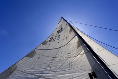 Low angle view of boat canvas against blue sky