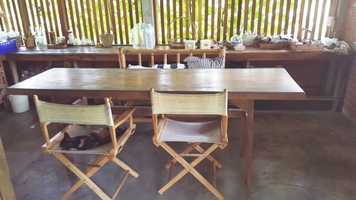 Empty chairs and table arranged in restaurant