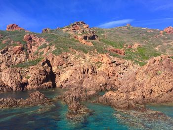 Scenic view of rock formation in sea against sky