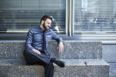 Young man sitting in office building