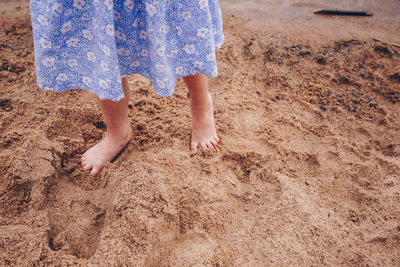 Low section of woman standing on beach