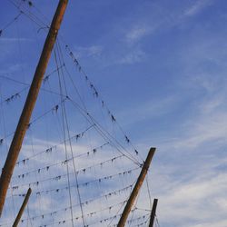 Low angle view of sailboat sailing on blue sky