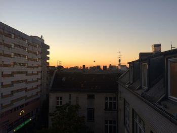 Buildings in city at sunset